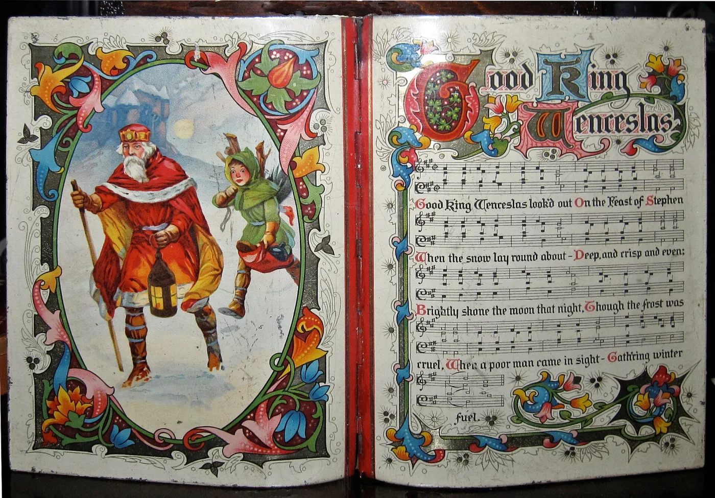 A biscuit tin lithographed with a medieval scene of King Wenceslas and his page in snow, in blues, reds and gold