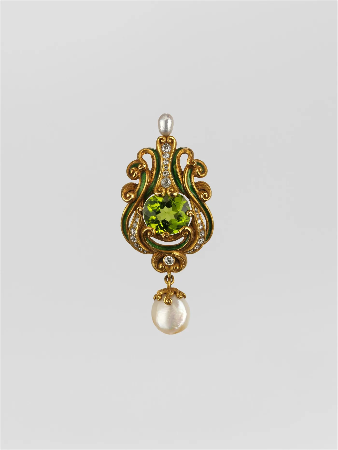 Gold brooch with scrolled arms in green enamel and small diamonds framing a large faceted green peridot, a small pearl above and a baroque pearl drop below