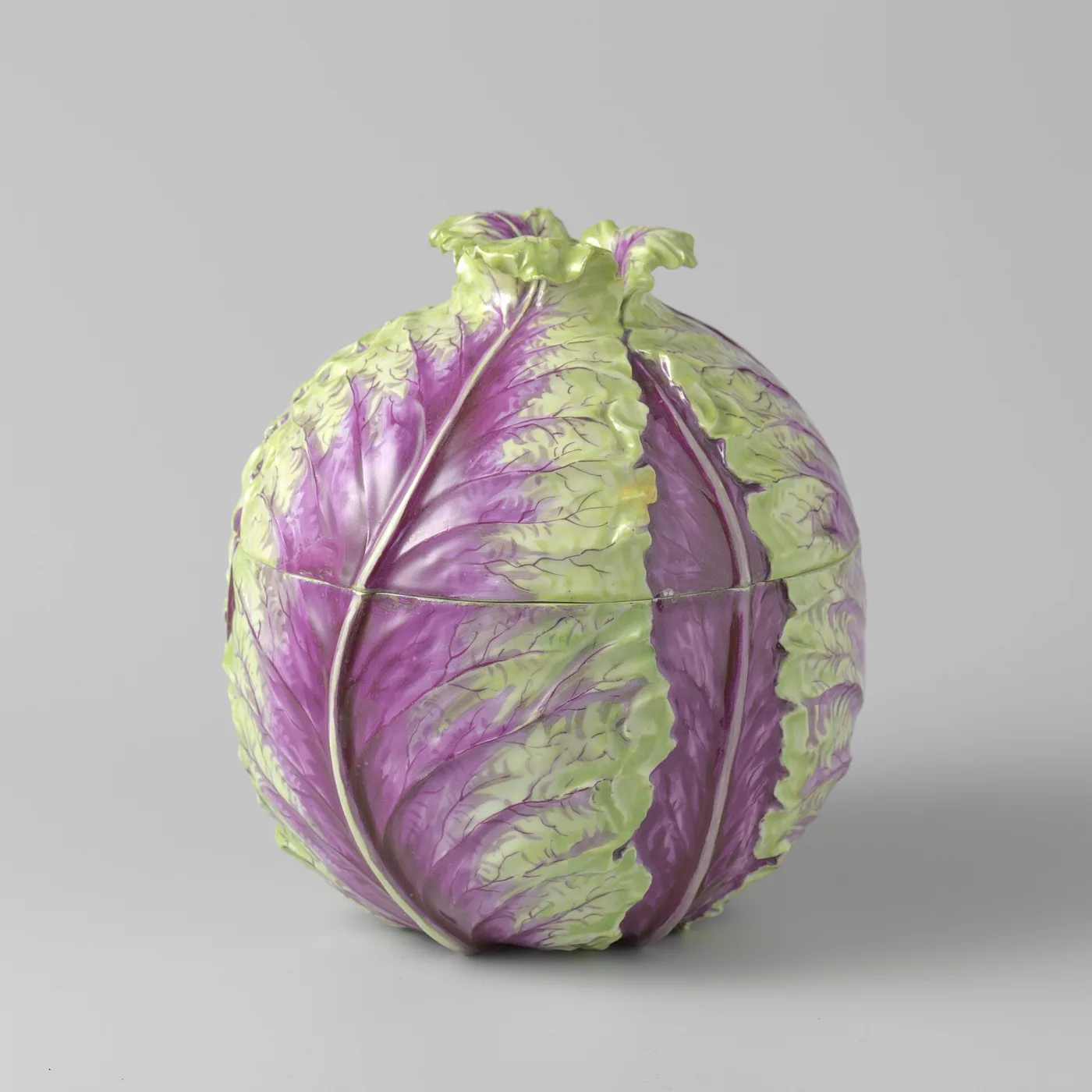 Porcelain tureen modelled as a red cabbage, purple and pale green leaves wrapping a domed lid