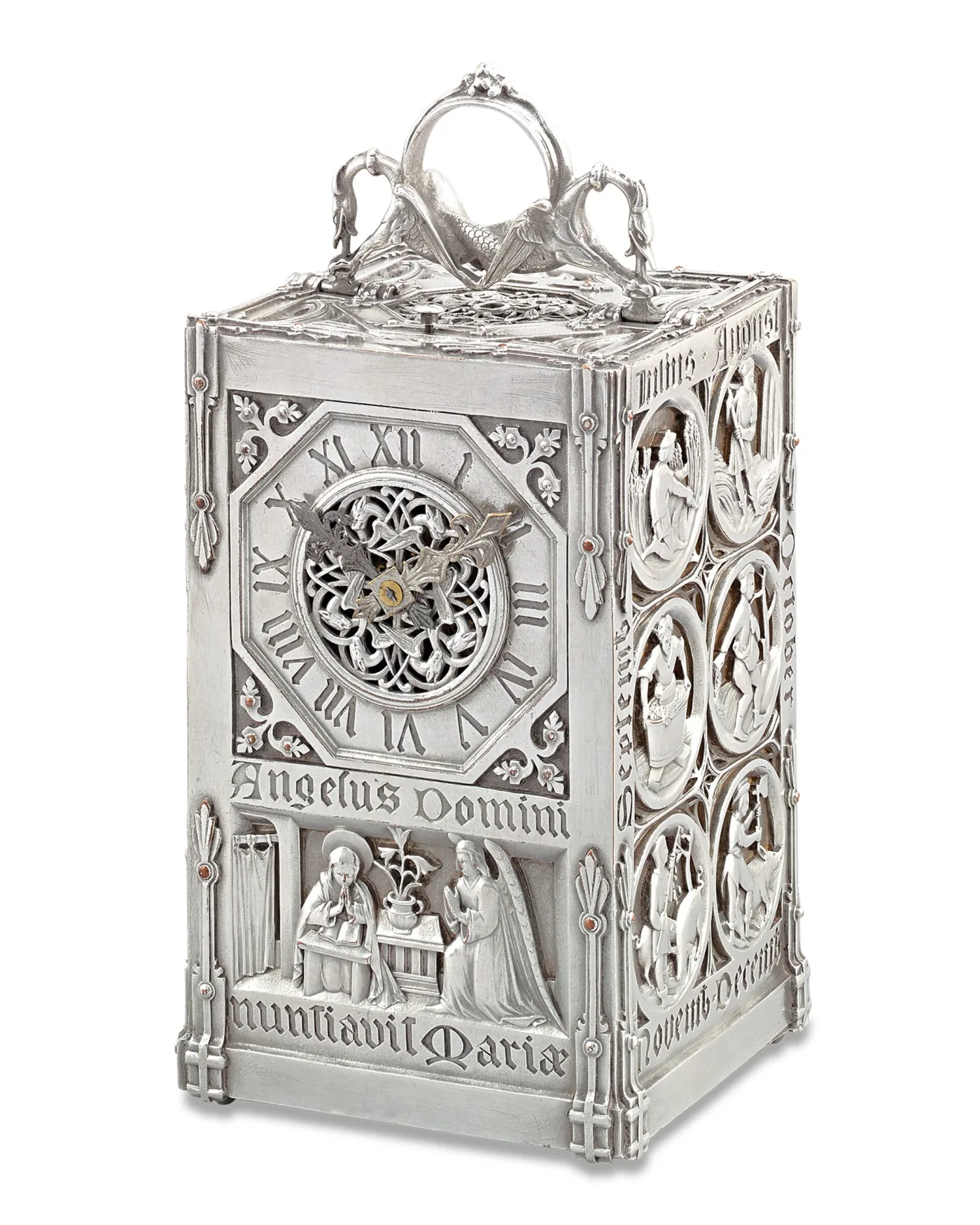 Silver Gothic Revival carriage clock cast with an Annunciation scene, a Latin inscription, month roundels down the side and a dragon-mounted handle