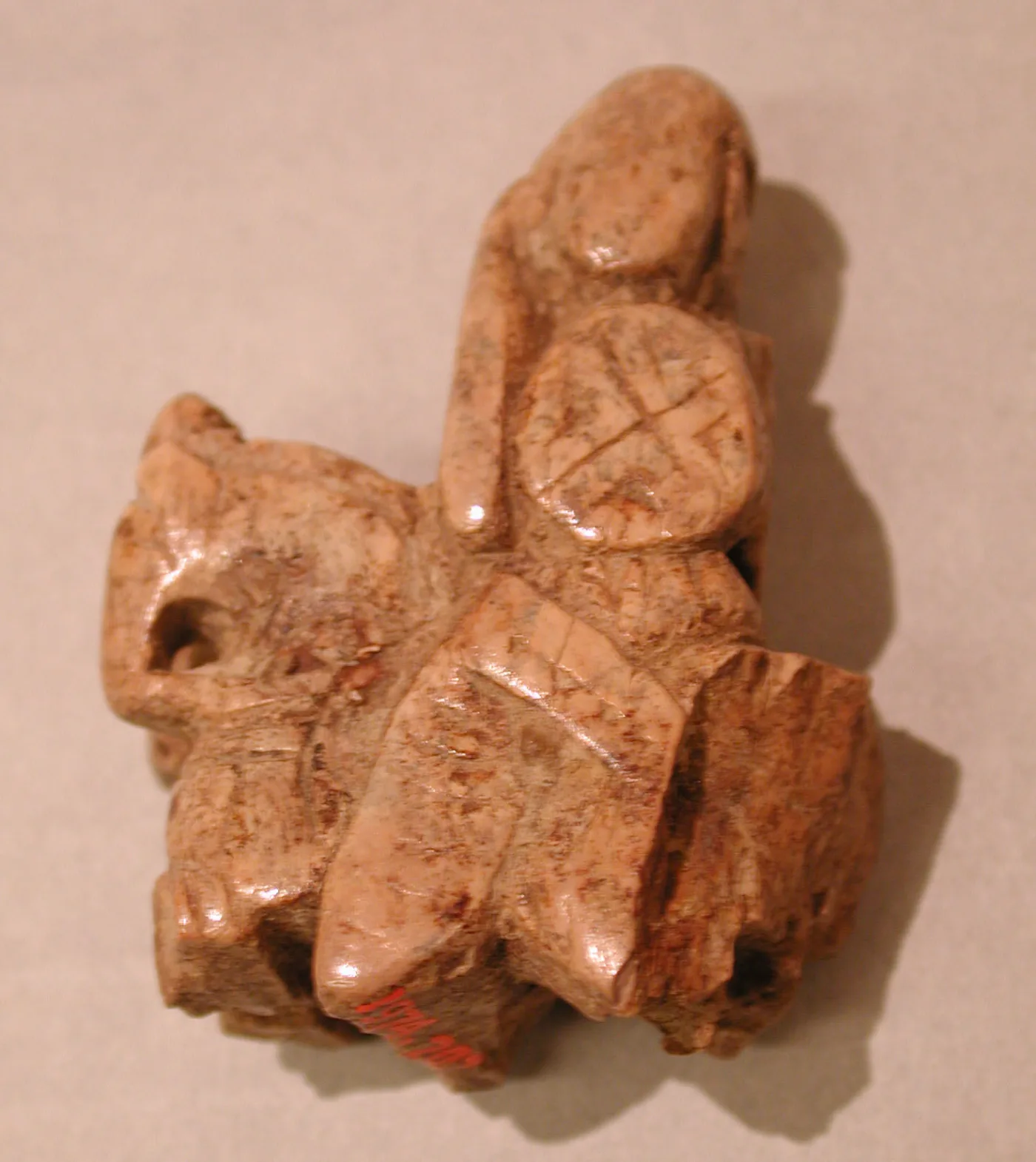 Small abstract chess piece in clouded glass, wedge-shaped with a deep notch cut into the top and incised lines on the sides