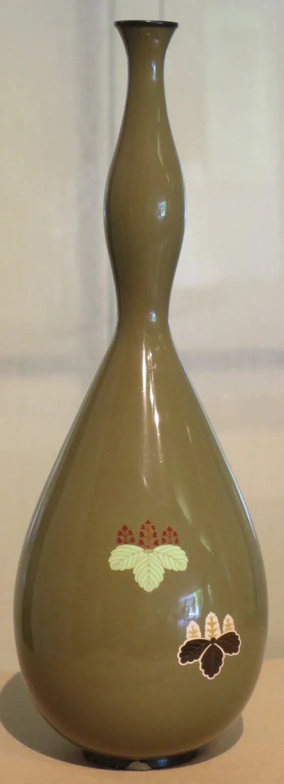 A tall double-gourd cloisonne vase with dense fine patterning and plain metal mounts at the rim and foot