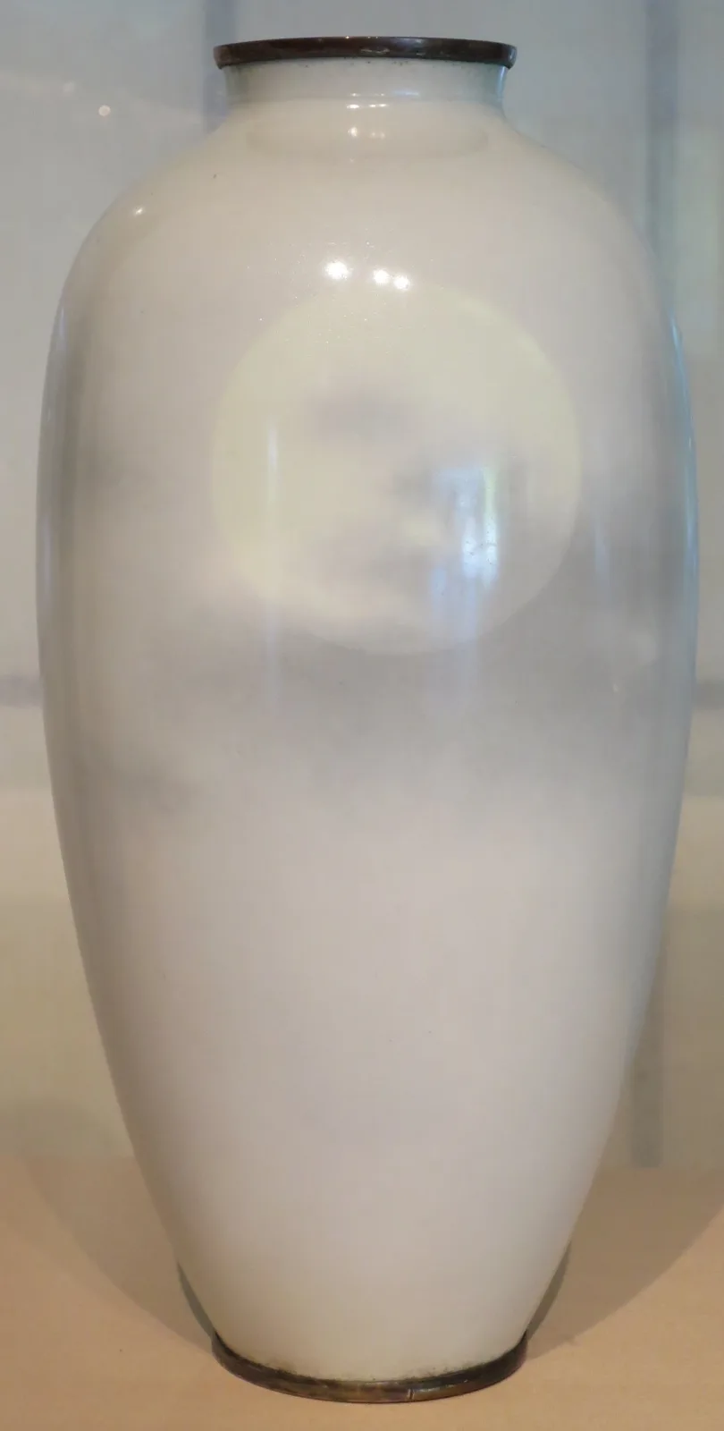 A tall cloisonne vase showing a moon behind drifting cloud, the image shaded continuously with no visible metal outlines