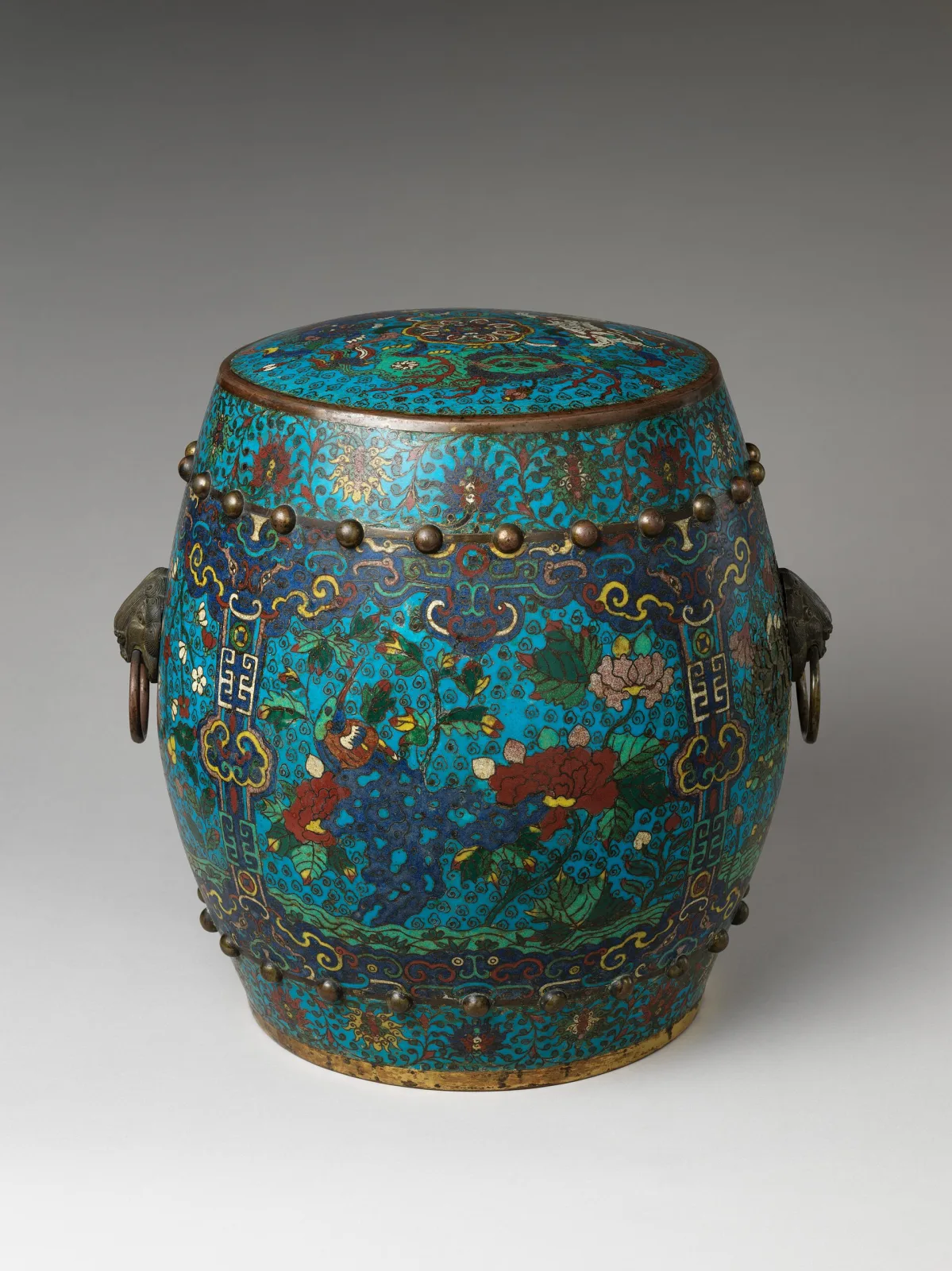 A barrel-shaped cloisonne garden seat decorated with birds and flowering branches