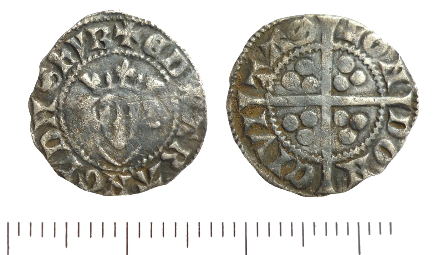 Two faces of a hammered silver penny: on the left a crowned facing bust inside a legend of Latin capitals, on the right a long cross dividing the field into quarters each holding three pellets, with a legend naming a city