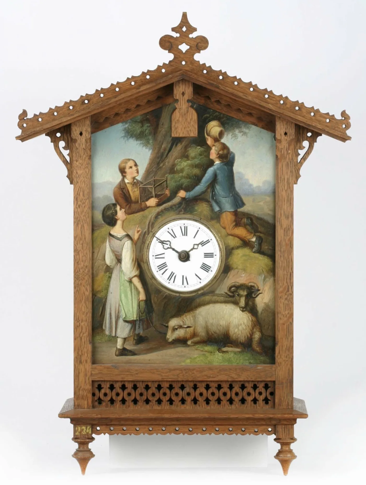 House-shaped cuckoo clock whose front is a painted scene of children with a birdcage and a resting sheep, with a small white enamel dial set into the painting