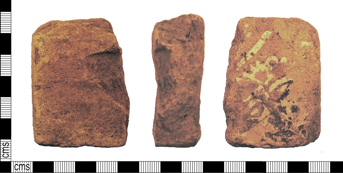 Three views of one broken medieval floor tile fragment photographed against a centimetre scale: the plain face, the edge showing the full thickness of the red clay body, and the decorated face with a yellow lion's head
