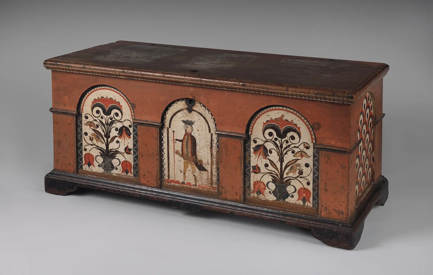 Red-painted Pennsylvania German dower chest with three arched white panels containing tulips, birds and a walking gentleman, on bracket feet