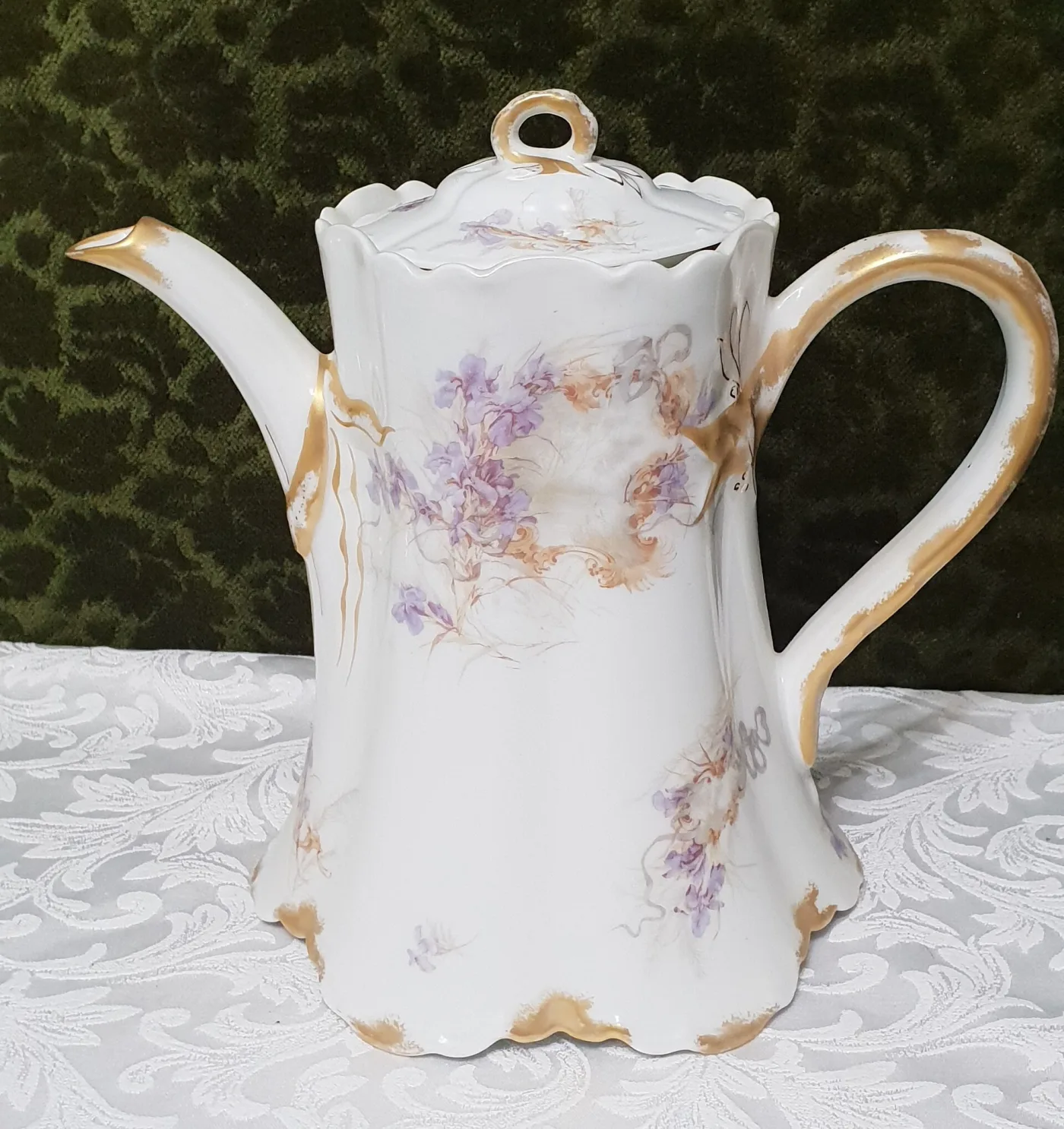 Tall porcelain coffee pot with a scalloped lid and gilded handle, decorated with lavender irises and a grey ribbon band