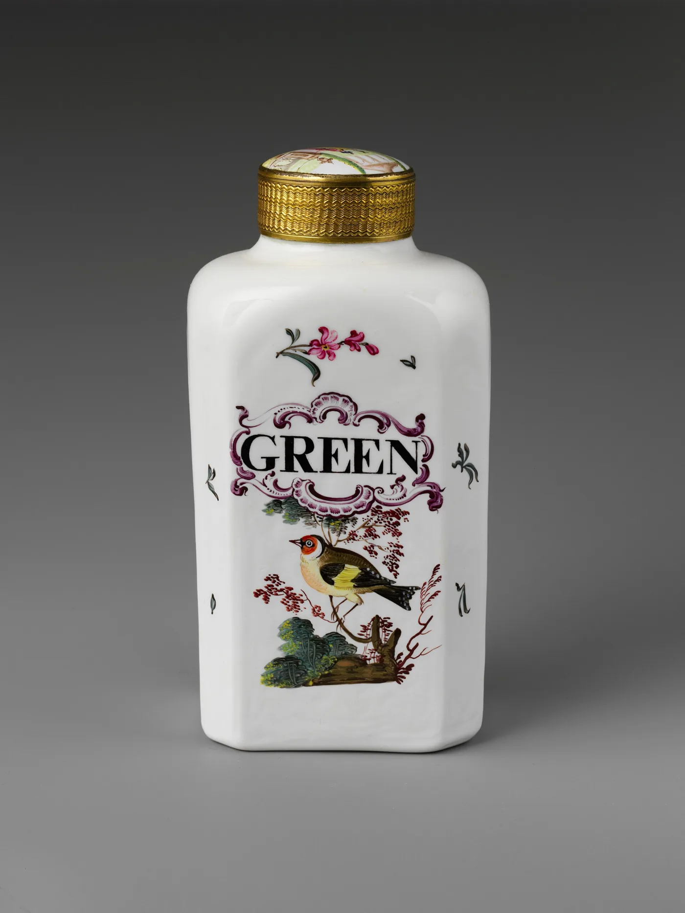 White glass tea caddy lettered GREEN in a rococo cartouche above a painted goldfinch, with a gilt metal collar and enamelled cover