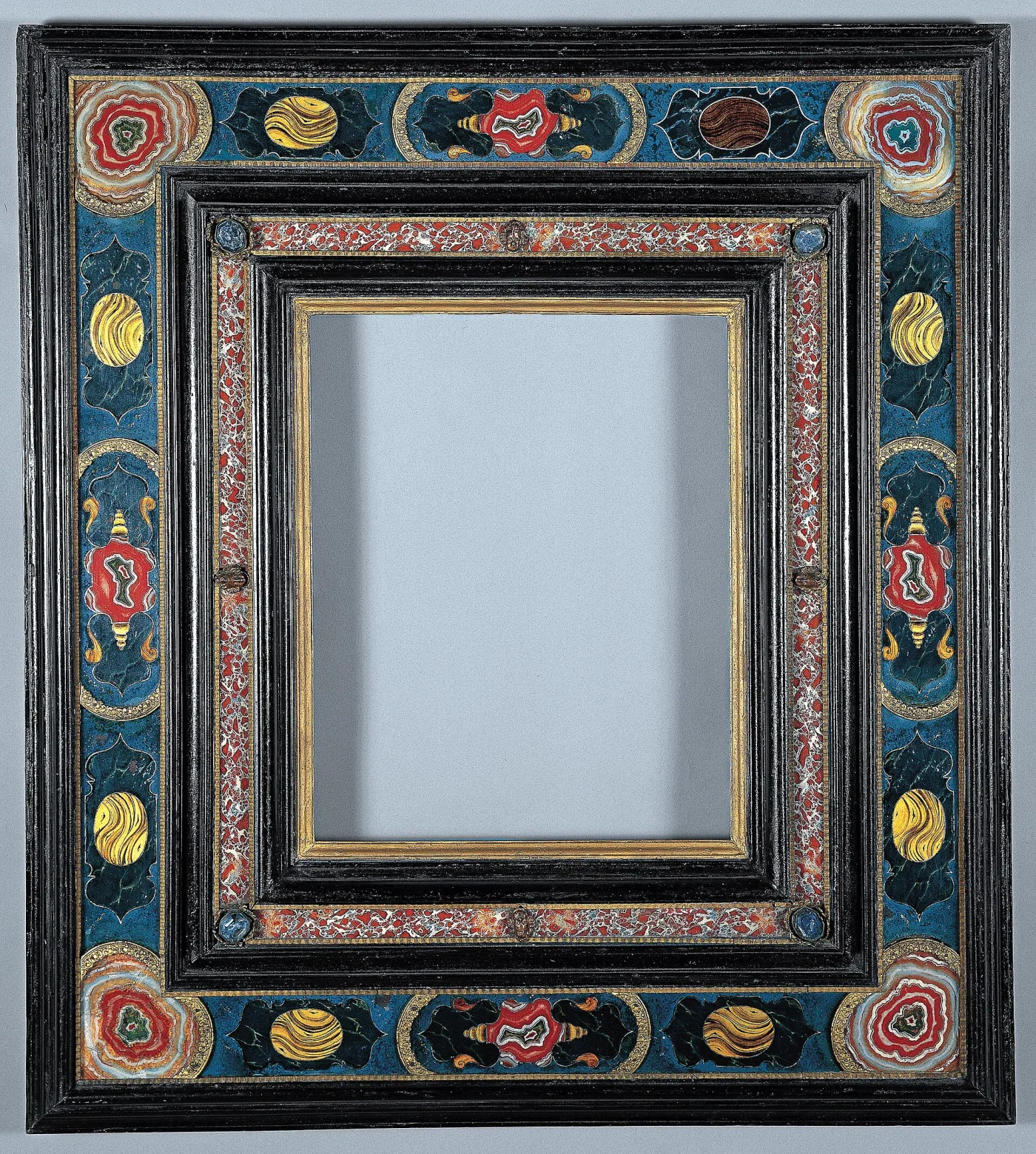Polychrome cassetta frame painted with stylised flowers and gilt scrolls on a blue ground, with a faux-marbled inner band and a black outer moulding, in fresh unworn condition
