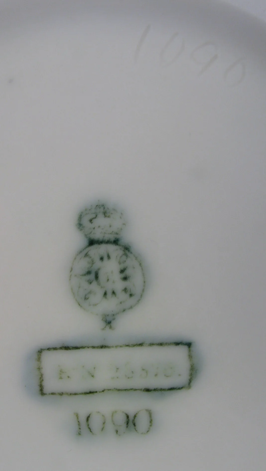 Green printed crown and circle mark above a boxed registration number, with the number 1090 printed below and impressed into the porcelain above