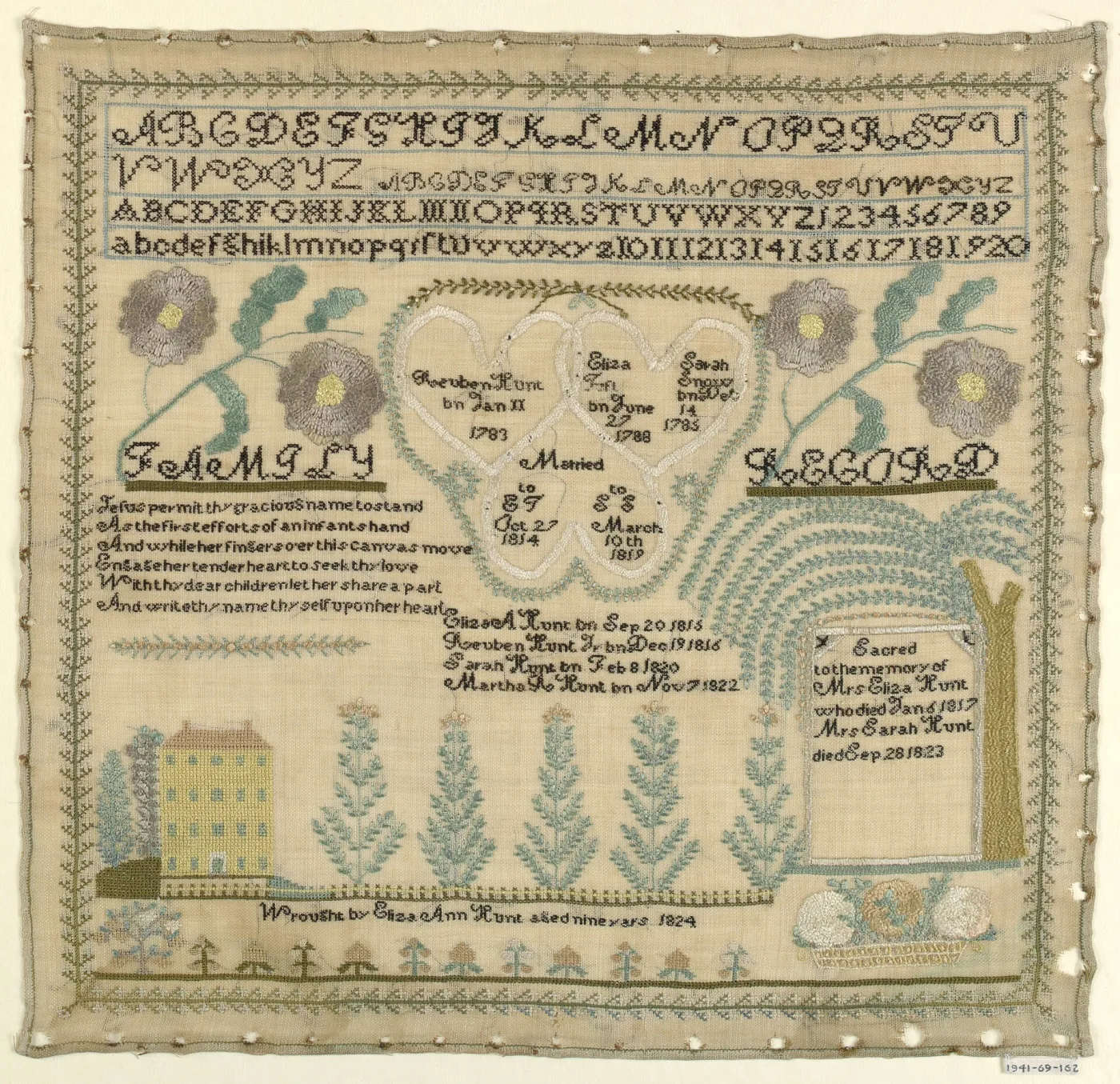 Square linen sampler with four stitched alphabets across the top, a family record of names and dates inside linked hearts, and a house, trees and a memorial plaque under a willow along the bottom