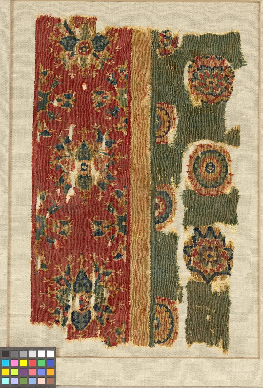 Small fragment of eighth-century wool tapestry weave in red, cream and dark tones, its edges frayed and the individual weft ribs clearly visible across the surface