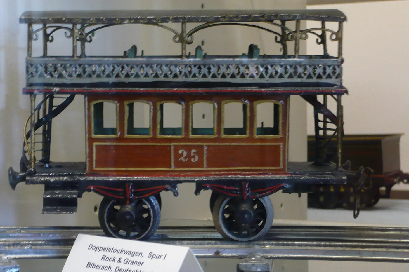 Tinplate double-deck railway coach with pierced railings, spiral staircases and open upper deck
