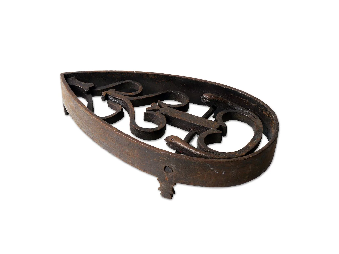 Pointed oval cast iron sadiron stand with two facing scrolled serpents forming the openwork top, seen from above at an angle