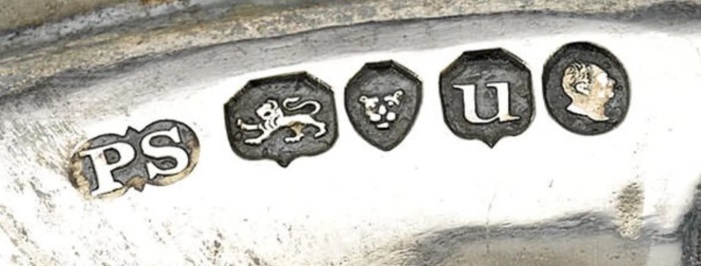 Five British hallmark punches struck in a row on silver by Paul Storr: maker's mark PS, lion passant, leopard's head, date letter u, and sovereign's head duty mark