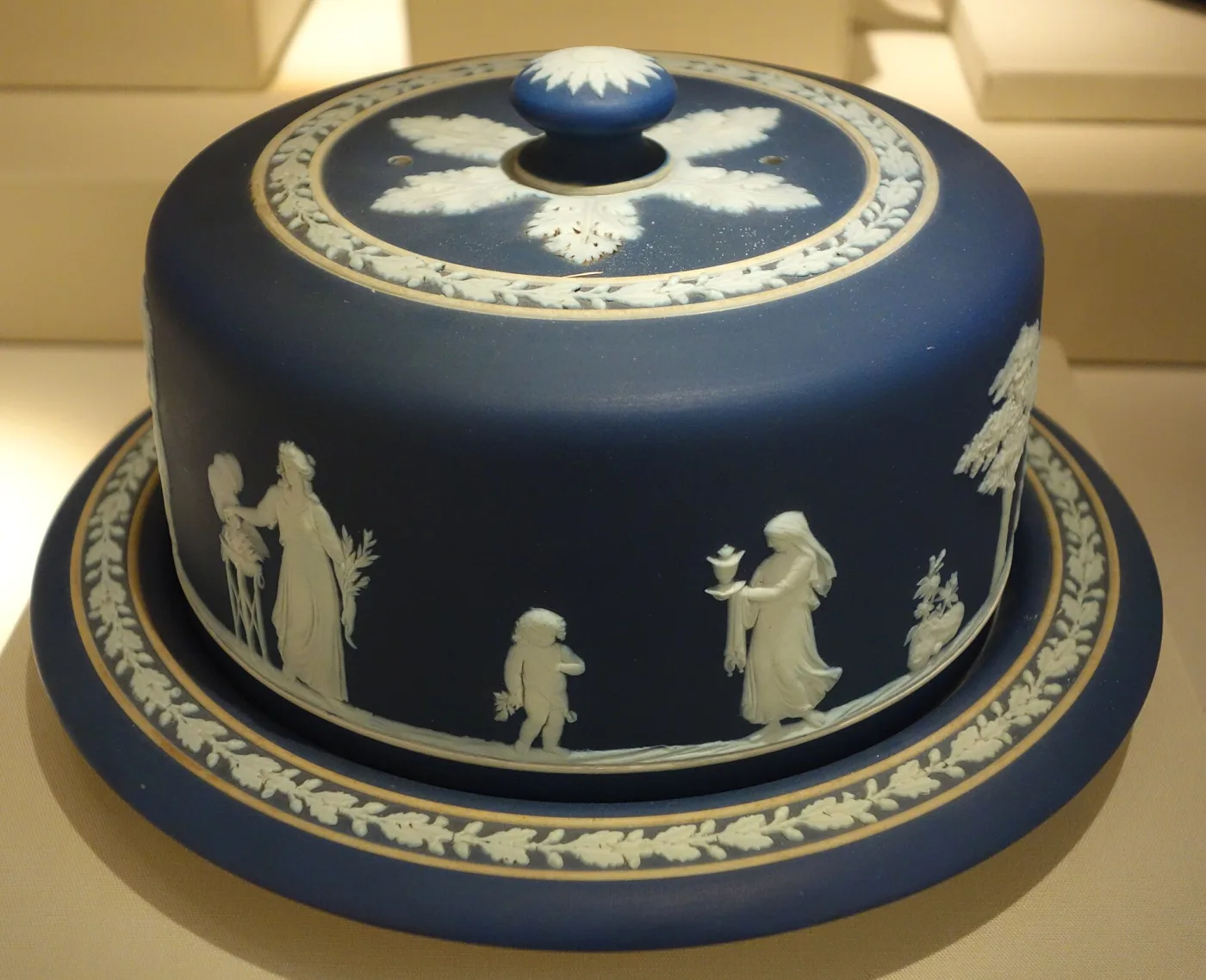 Dark blue Wedgwood jasper covered cheese dish and stand with white classical figures and oak leaf borders